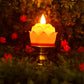 Close-up of lotus shaped LED candle with flickering effect on ornate holder