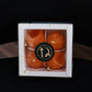 Lit laddu shaped decorative wax candle brightening traditional puja thali
