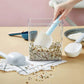 A large plastic measuring spoon shown scooping flour from a bag.