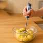 Close view of stainless steel potato masher spring and handle