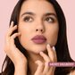 Model applying Merry Mulberry Liquid Lipstick for a matte finish.