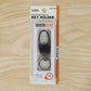 Metal key holder with rotating swivel on plain white background