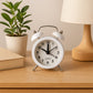 Classic twin-bell analog alarm clock with its iconic hammer striker.