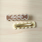 Detailed close-up of secure snap mechanism on wavy hair clip