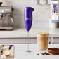 Handheld milk frother creating coffee foam efficiently