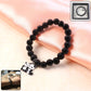 Close-up view of black beaded bracelet showcasing detailed panda charm.