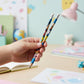 Multiple cartoon-printed graphite pencils arranged neatly showing creative designs