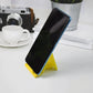 Foldable plastic phone stand in use holding smartphone securely