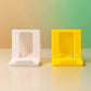 Foldable plastic phone stand laid flat for storage