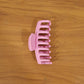 Model wearing elegant pink hair claw clip in styling