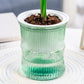 Side view of bamboo-style self-watering planter pot