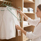 Space-saving plastic hangers arranged in wardrobe