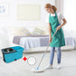 User easily moving the spin mop bucket with its integrated wheels and puller handle.