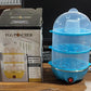 Compact electric egg cooker with all accessories for easy breakfast preparation.