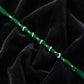 Close-up of green pearl beaded rakhi design