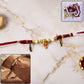 Ganesh charm rakhi with feather pendants on beaded thread