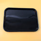 Close-up detail of smooth surface and rounded corners on black plastic serving tray