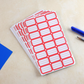 Red rectangular self-adhesive label stickers sheet close-up