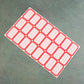 Close-up photograph of red and white self-adhesive rectangular label stickers