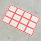 Close-up view of red and white rectangular self-adhesive label stickers