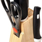 Stainless steel kitchen knives set with black handles arranged on wooden block