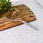 Potato masher placed in kitchen setting showing ergonomic handle