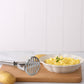 Close-up of stainless steel potato masher with sturdy design