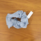 Model wearing soft fabric hair scrunchie in a stylish ponytail