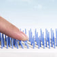 Close-up view of the Self-Cleaning Hairbrush's innovative massage bristles