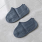 Grey silicone rain shoe cover on white background