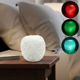 LED crystal table lamp with colour-changing ambient glow on a bedside table