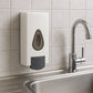 Two wall mounted soap dispensers in a white bathroom, highlighting design.