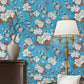 Applied floral wallpaper roll on wall showcasing vibrant pattern
