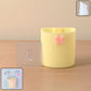 Wall-mounted toothbrush holder with butterfly design on a bathroom wall