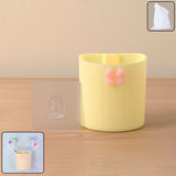 Wall-mounted toothbrush holder with butterfly design on a bathroom wall