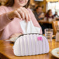 Creative seashell tissue holder with pink bow accent