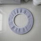 Stretchable toilet seat cover shown separately for demonstration