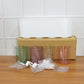 Plastic wall toothbrush rack with four inverted cups and grooming accessory slots