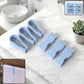 Multipurpose towel clips in use on a towel rod in a modern kitchen