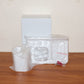Lifestyle image of wall mounted toothbrush holder with toothbrush and toothpaste inside.