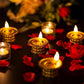 Multiple golden water sensor diyas illuminating a traditional Indian setting.
