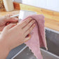 Hand holding a versatile kitchen cleaning towel, demonstrating ease of use.