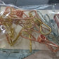 Lifestyle shot of sturdy stainless steel clips being used to hang clothes on a line.
