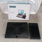 Lifestyle shot of the foldable laptop stand in use with a laptop.
