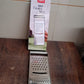 Stainless steel grater and slicer placed in a kitchen setting for food prep