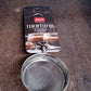 Stainless steel tea strainer positioned within a kitchen setting