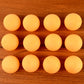Orange table tennis balls ideal for training and tournament use displayed