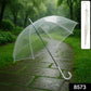Clear transparent dome umbrella in use on a rainy street with full visibility