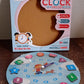 Wooden educational learning clock toy displayed on table with colorful blocks