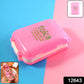 Open pink pill box showing dual-sided compartments for pills